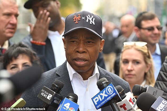 Eric Adams, the 64-year-old Democrat, marched in the 80th Columbus Day Parade on Monday wearing a dark baseball hat bearing the logos of both the Yankees and Mets.