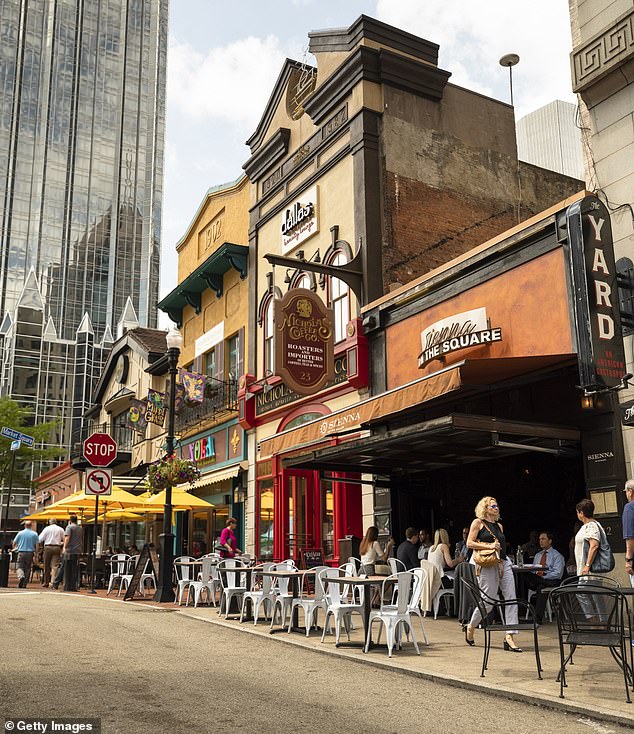 The Steel City is no longer just about heavy industry - it is also a hotspot for sports and sandwiches - and now also for smart house hunters who want to get more value for their money (photo: people walk past the restaurants and shops on the market square in the center )