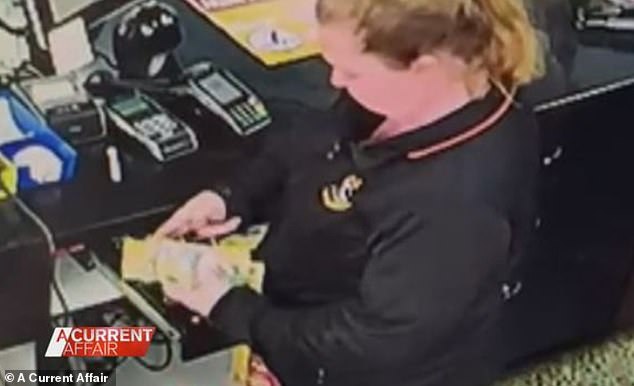 CCTV footage shows the woman counting $50 notes before pocketing the money (pictured)