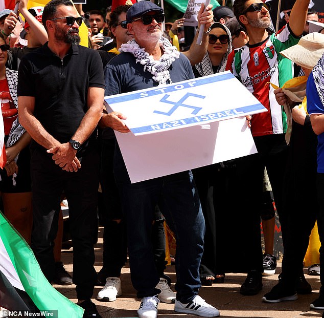 Alan Yazbek was charged with knowingly displaying a Nazi symbol in public after officers caught him carrying a swastika sign during a protest in Sydney on Sunday.