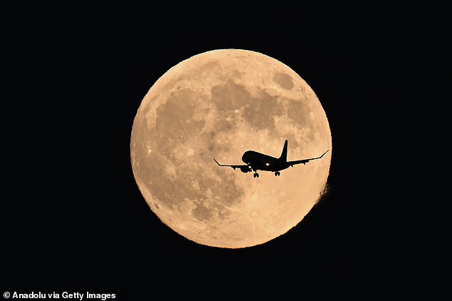 A supermoon is formed when the moon approaches its closest point to Earth. During tonight's supermoon, the moon will be nearly 17,000 miles closer than normal. Pictured: A plane flies over San Francisco for the Hunter's Supermoon