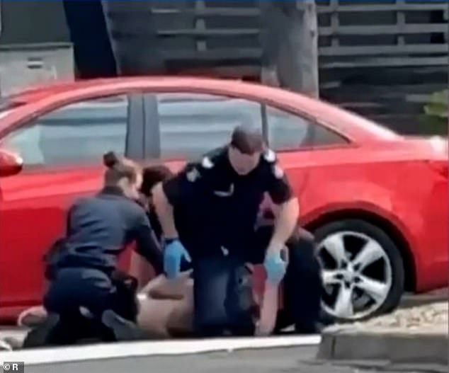 A male officer knelt on the man's neck several times during the dramatic arrest (photo)