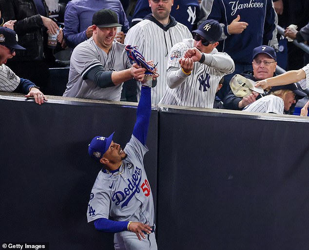 Yankees fan Austin Capobianco tried to snatch the ball out of Mookie Betts' hand on Tuesday