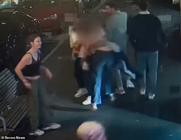 CCTV footage of the incident shows one of the men waving a Brisbane Lions scarf in the women's faces before Poppy (pictured centre) grabs his shirt and waves it at his head.