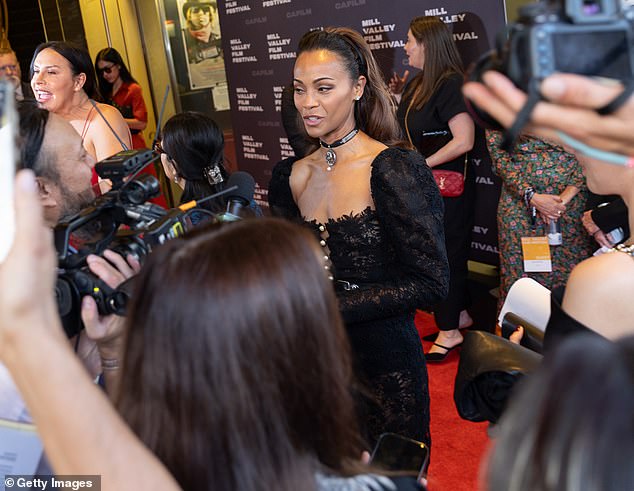 The top portion of the ensemble was secured with off-white buttons, while a black leather belt was wrapped around her waist for a stylish flair