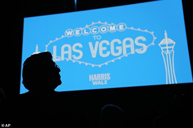 A supporter stands in front of the Welcome to Las Vegas jumbotron during a rally at the Craig Ranch Amphitheater Thursday evening