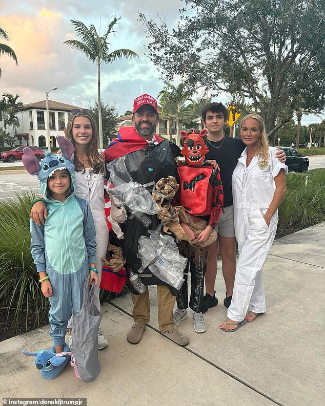 Donald Trump's eldest son poses with his family as they go trick-or-treating