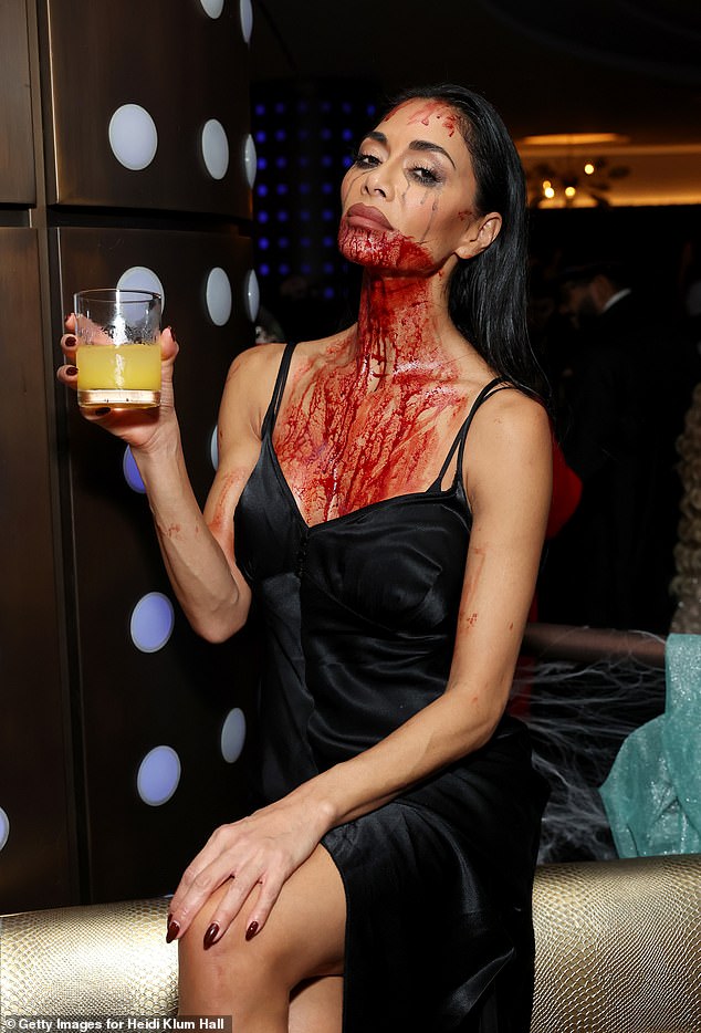 The blood-soaked star enjoyed a drink at the star-studded bash