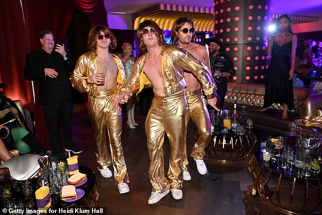 The trio were in fine form as they struck a number of poses in their striking outfits that echoed the Bee Gees' gold-toned look from 1977.