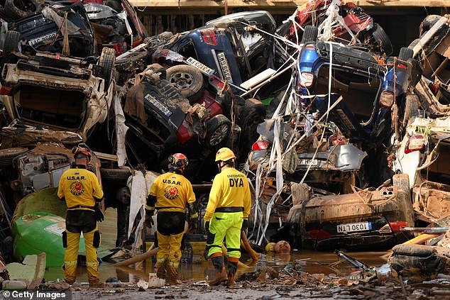 Members of the fire brigade, part of a search and rescue unit, carry out work as cars and debris block a tunnel following the recent flash floods in the nearby municipality of Benetusser on November 1, 2024 in the municipality of Benetusser in Valencia, Spain