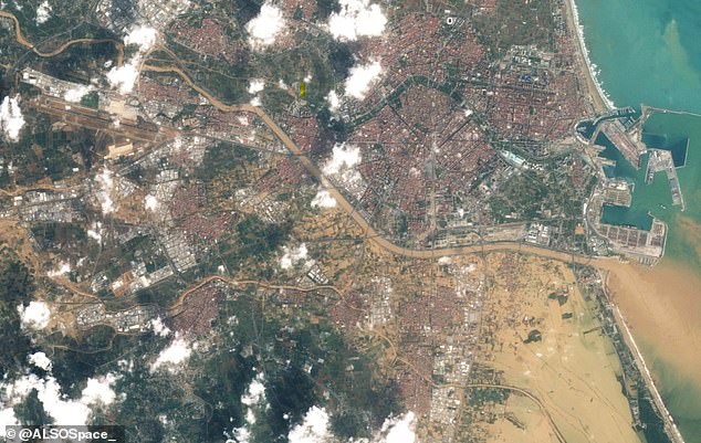 A satellite image of Valencia clearly shows where the worst-hit parts of the city are, with brown water covering large areas of land south of the city.