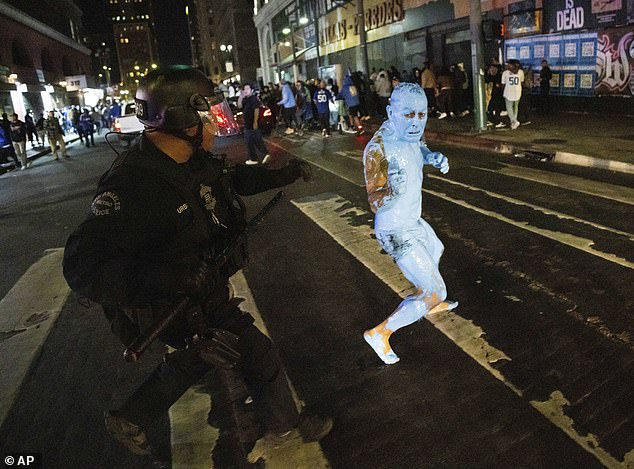 The man was photographed running from the police in the street after the victory