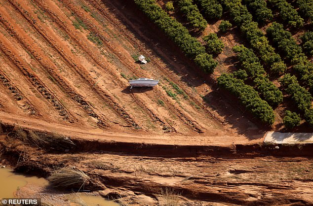 A boat becomes stranded in a field after flash flooding in the Valencia region