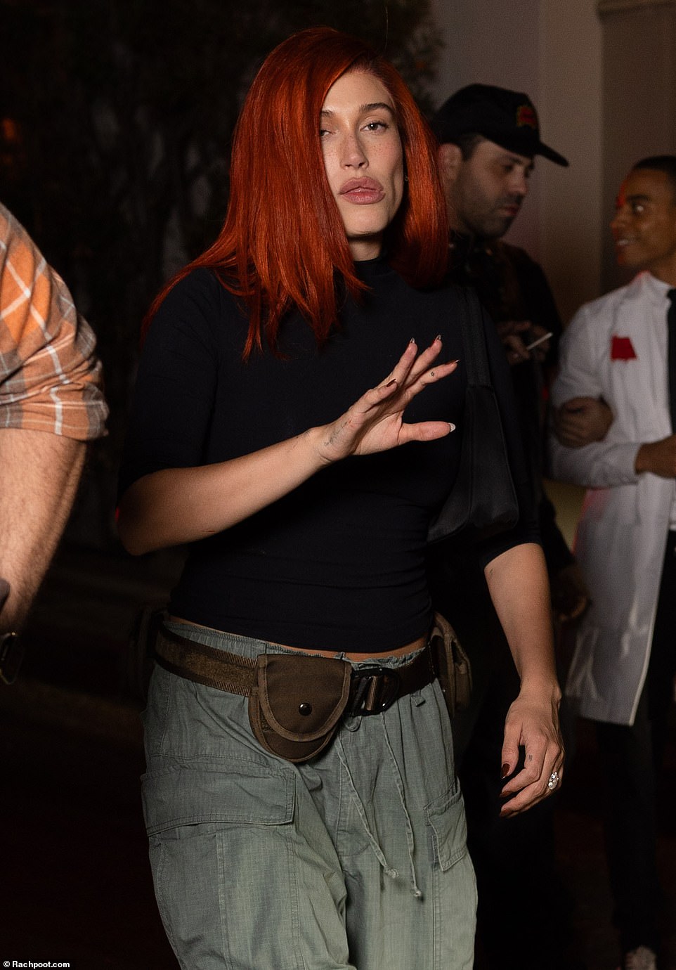 Meanwhile, new mom Hailey, 27, was Kim Possible as she dressed in slouchy jeans, a black top and wore a red wig as she attended the same party without her husband Justin