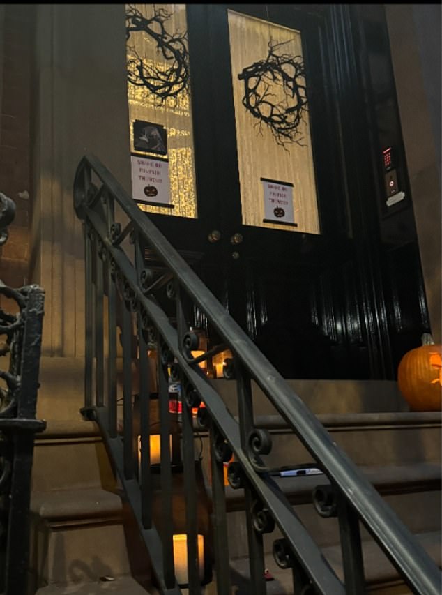 However, as night fell on All Hallows Eve, photos show the sidewalk decorated with nothing more than a few candles and a single jack-o'-lantern