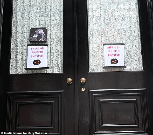 What appears to be surveillance footage of the robbery is also taped to the front door of her home