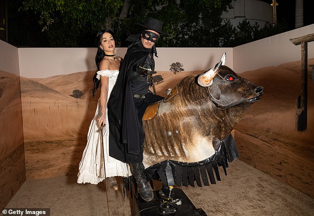 The couple certainly got into the spirit as they posed for some fun snaps before jumping on a mechanical bull at the bash