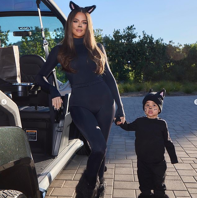 She was also seen leaning on the white and gray cart as she posed with son Tatum