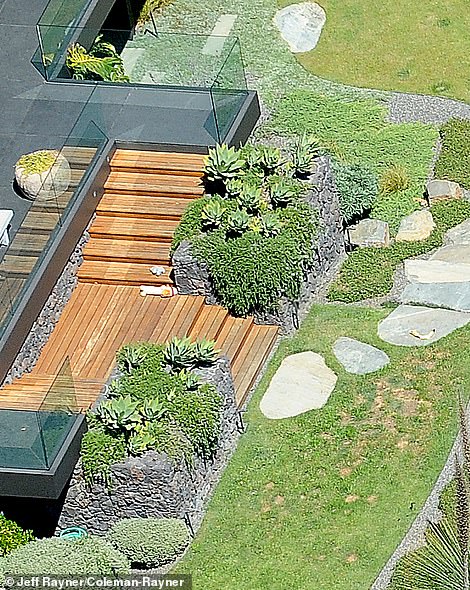 And while her dogs have fun in their spacious doghouse, the famous Zen star can relax on her own Asian-inspired patio with a bubbling water pot, a spiritual temple structure and black gravel with round shapes raked into it.