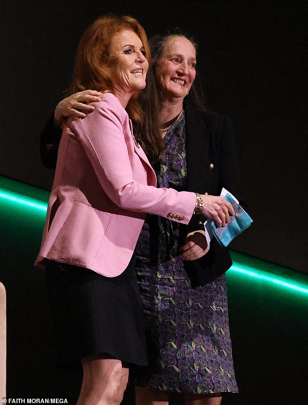 FRIENDLY: The tactile royal was snapped hugging Tess Woods, who hosted the literary event in Perth on Friday