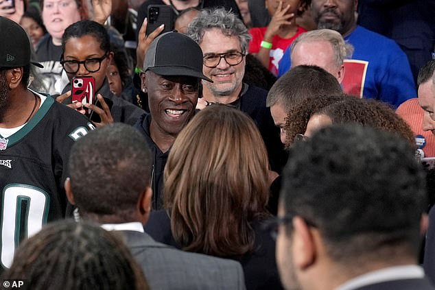 Democratic presidential candidate Vice President Kamala Harris, bottom center, greets 'Avengers' actors Don Cheadle, top center left, and Mark Ruffalo, top center right, after speaking at a community meeting