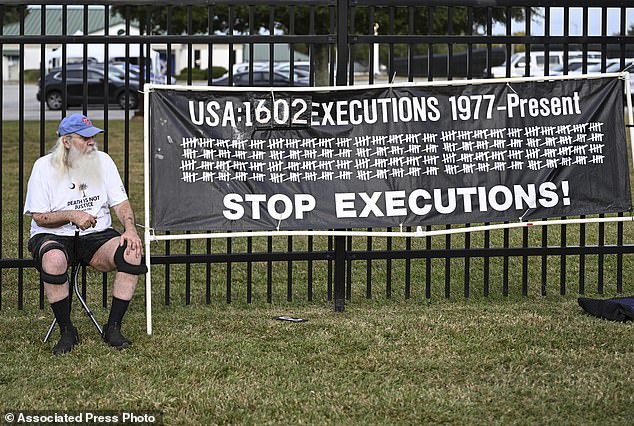 A protester looks on ahead of the planned execution of Richard Moore