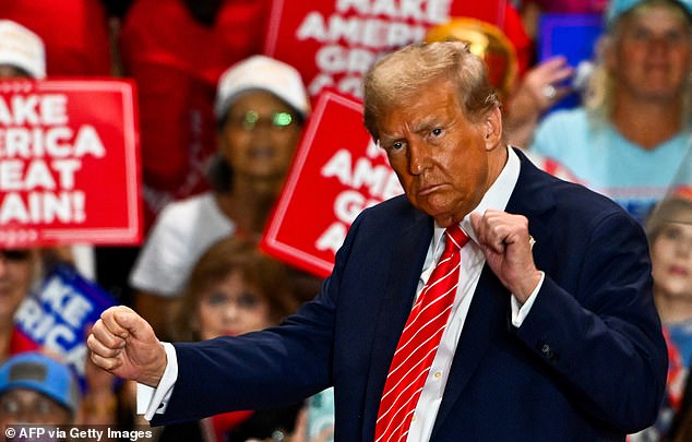 Republican presidential candidate Donald Trump dances as he leaves a campaign rally in North Carolina on October 30, 2024