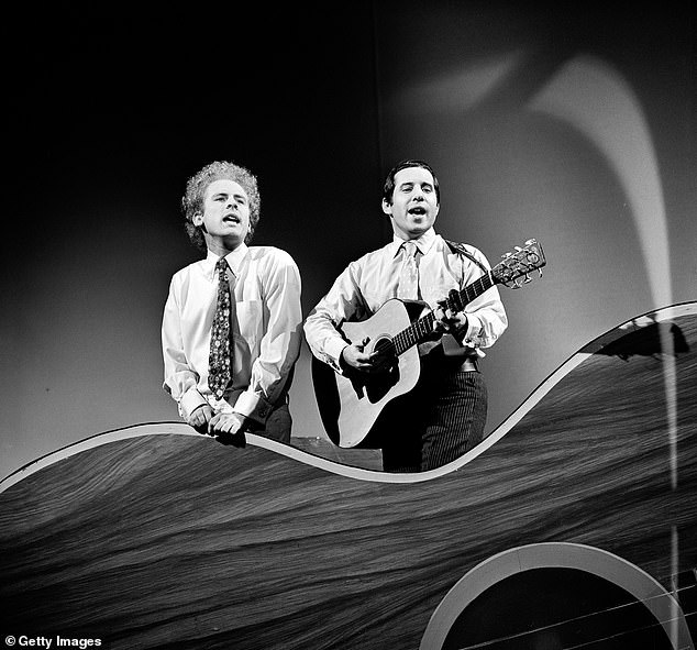 Simon and Garfunkel sing and play guitar while performing on the CBS variety program 'The Red Skelton Hour' in 1966