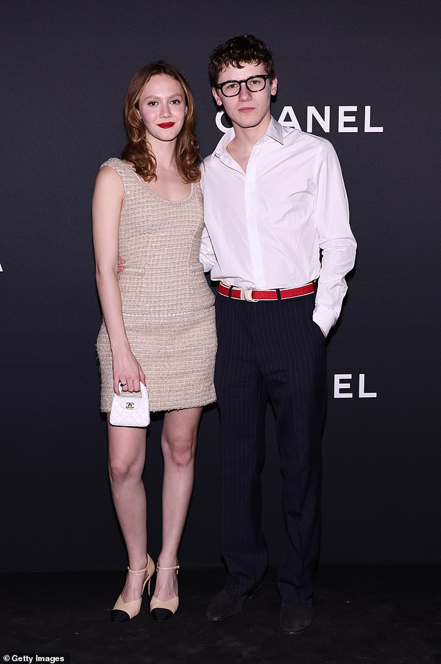 Shows off her legs in Chanel while with Sam Nivola, son of actors Emily Mortimer and Alessandro Nivola