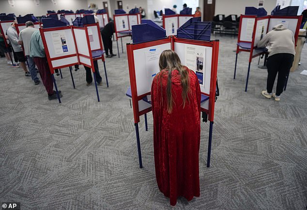 Voters fill out their ballots during in-person early voting at the Hamilton County Board of Elections, Thursday, Oct. 31, 2024, in Cincinnati