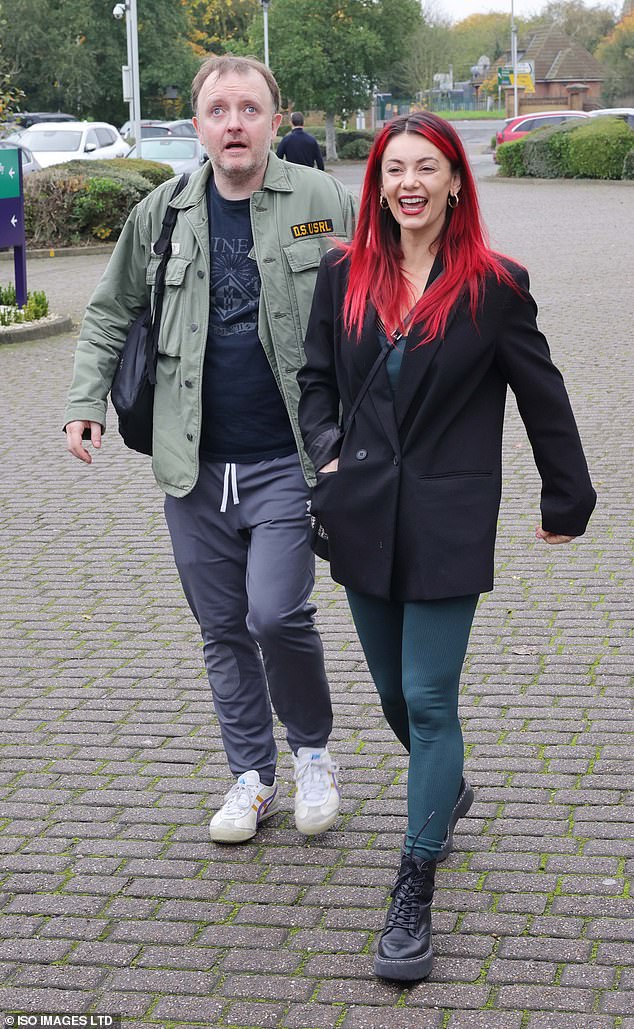 Dianne smiled as she walked around in a green unitard with a black button-up coat and black Dr. Marten boots, as she let her bright red locks fall loose over her shoulders