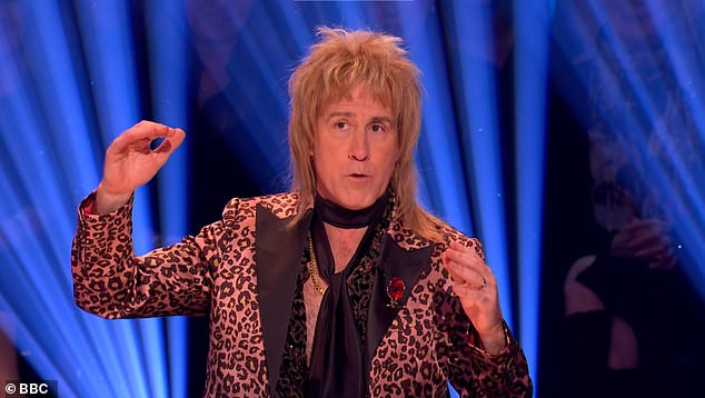 He looked completely unrecognizable in a blonde wig and a vibrant leopard print suit