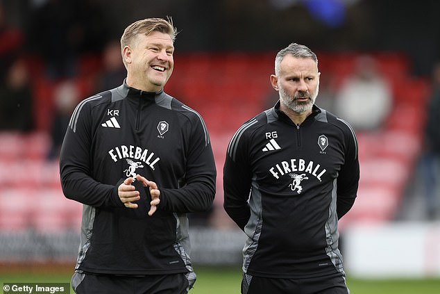 Football director Giggs pictured before the match with manager Karl Robinson (left)