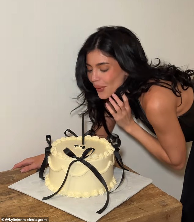 For the milestone, the Kylie Cosmetics founder celebrated with a yellow cake and candle while dressed in a black leather ensemble that appeared to include a halter top and skirt combo