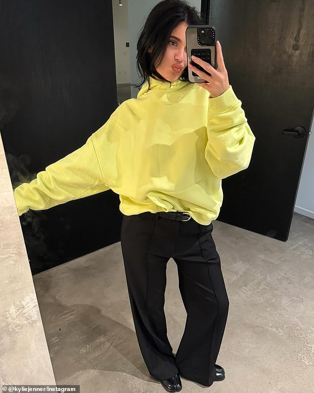 The youngest of the Kardashian-Jenner brood also shared a full-body photo of herself in black pants, a yellow hoodie and black leather shoes as she pursed her lips.