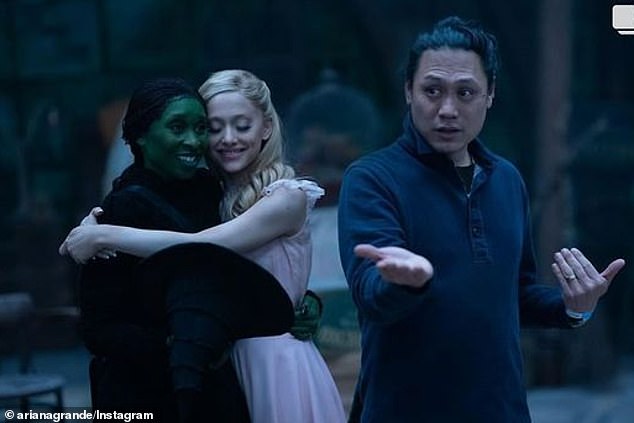 She also posted a photo of the two stars cuddling next to Wicked director Jon M. Chu, along with the first reaction from moviegoers who saw Sunday's premiere in Sydney, Australia.