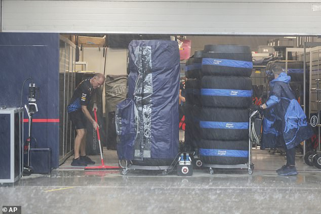 Staff and teams had to sweep away the rain to try and get the track ready for competition