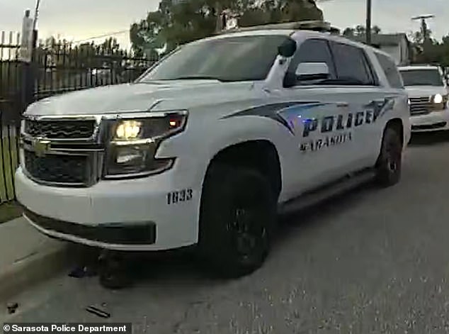 The eight-year-old's dirt bike ended up under the police car after he was hit