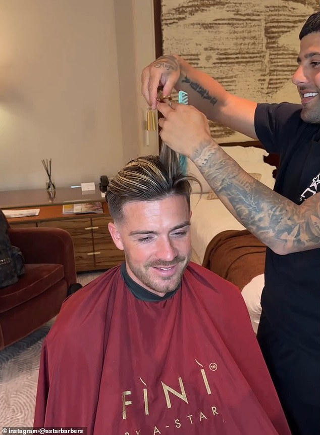 Manchester City star Jack Grealish smiles as he gets a haircut from Alsanawi this summer