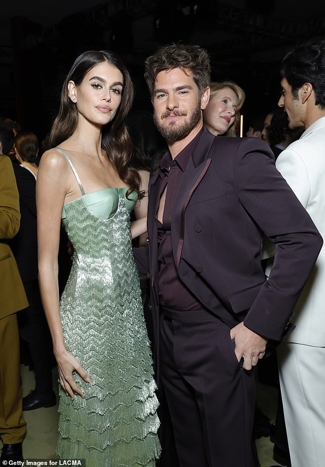 Cindy Crawford's daughter most recently joined Andrew Garfield, who put on a dapper show in an aubergine-colored suit with his shirt half-unbuttoned, to pose for a photo