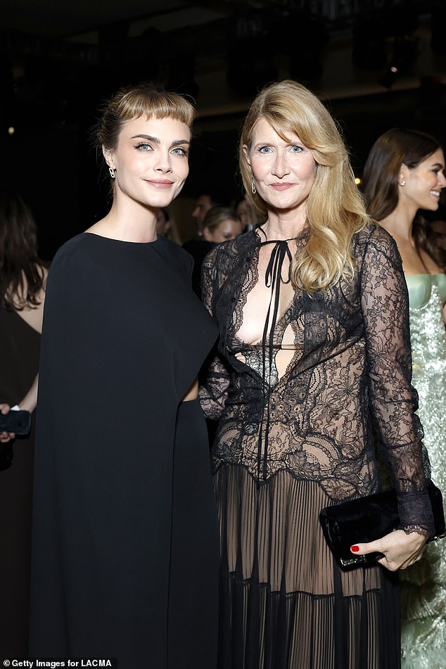 Laura Dern showed off her figure in a plunging lace dress as she beamed for photos with Cara