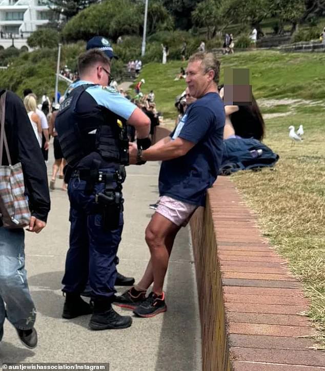 The man, who has yet to be formally identified, was confronted by police at Sydney's Bondi Beach for wearing the 'provocative' shirt