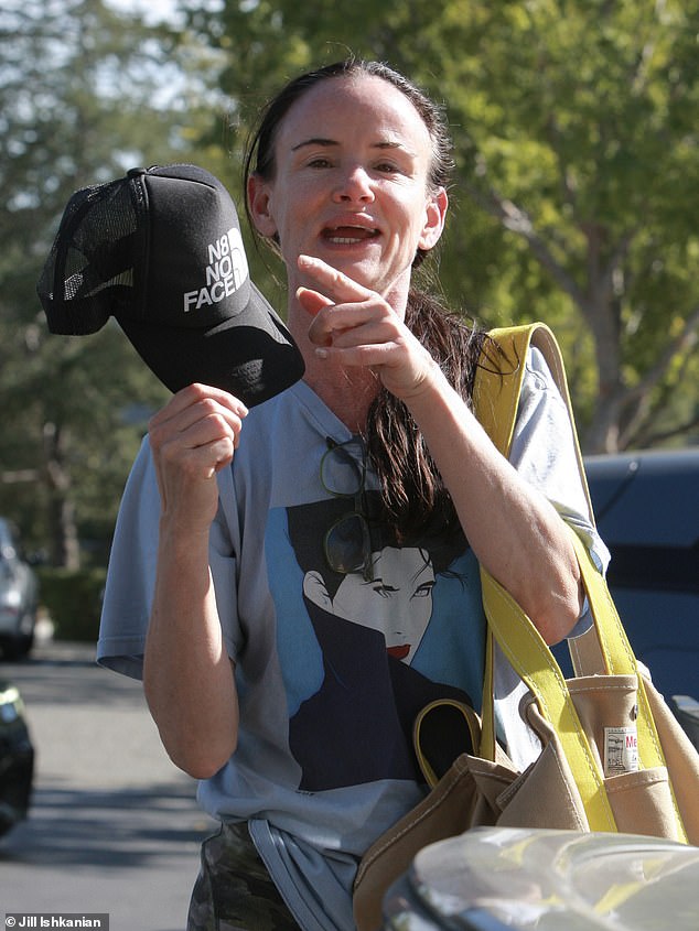 The 51-year-old showed off her fit and trim figure with tight camouflage nylon cycling shorts, a gray T-shirt decorated with an image of American pop artist Patrick Nagel and a black baseball cap with a parody of the North Face logo.