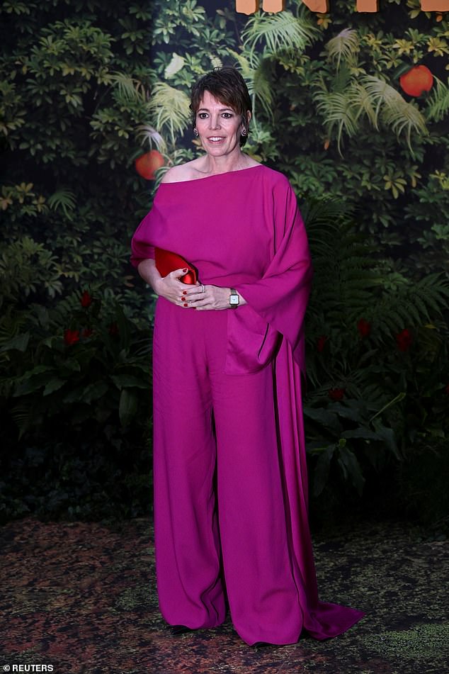 She carried a statement red handbag and earrings and wore her brunette locks in a short, cropped hairstyle