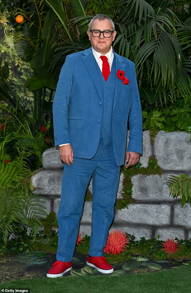 Downton Abbey star Hugh Bonneville, 60, looked dapper in a bright blue suit and red tie