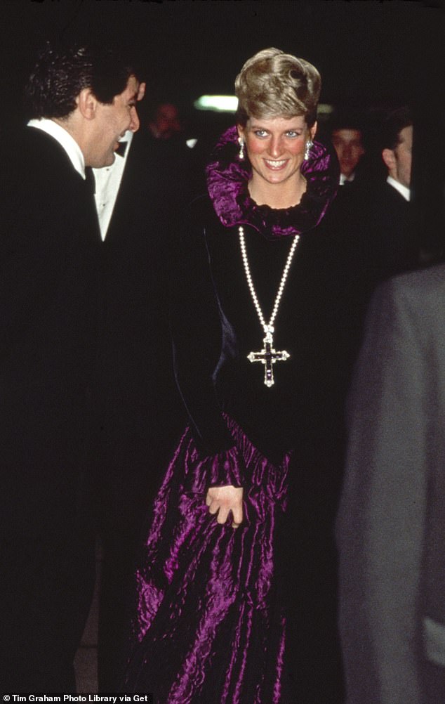 Diana, Princess of Wales, is pictured wearing the pendant on a pearl necklace as she attended the Birthright charity gala in 1987, where she wore a purple velvet Catherine Walker dress.