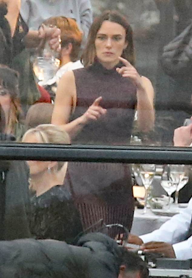 Keira looked sensational in a maroon backless dress for the scenes as the characters attended a fancy dinner