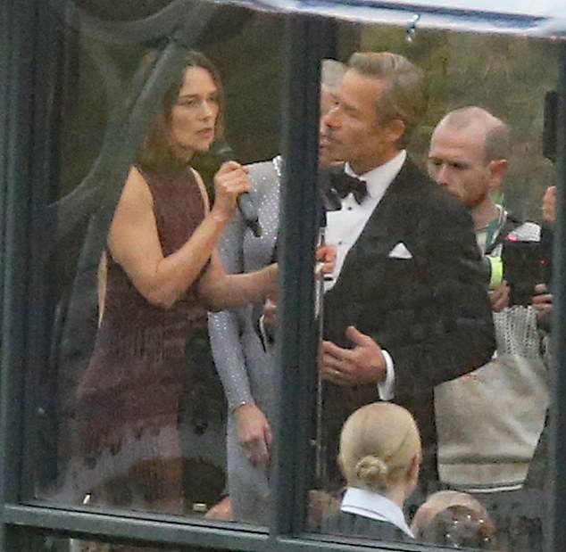 Co-star Guy Pearce, 57, was also on set and cut a dapper figure in a classic tuxedo as he and Keira took to the stage during a tense scene.