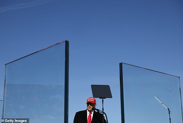 Trump said, “To get me someone would have to shoot through the fake news, and I don't mind that,” as he complained about the installation of the thick glass barrier