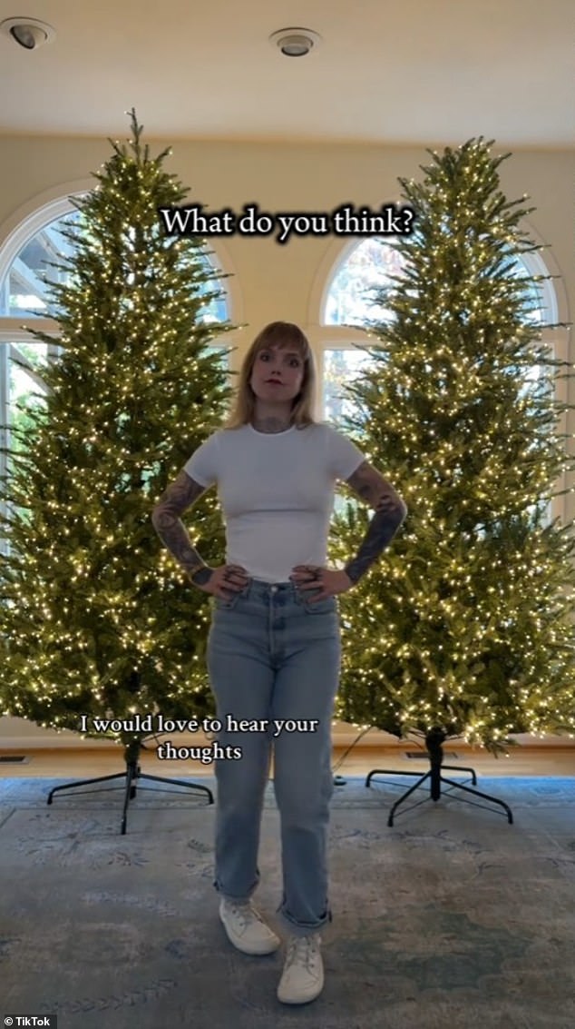 Sara Beth Clark poses in front of both of her Home Depot Christmas trees